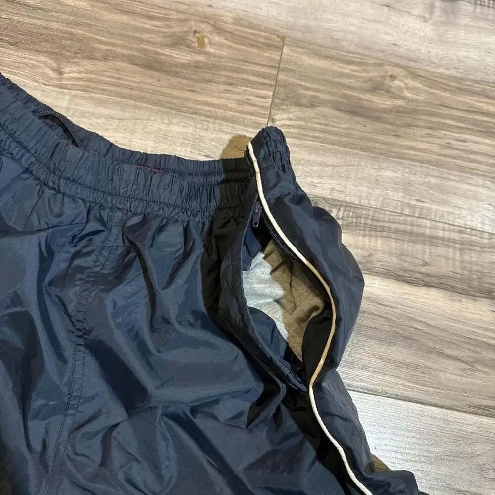 Vintage Men's Navy Blue Nylon Track Pants with White Side Piping and Zip Cuffs